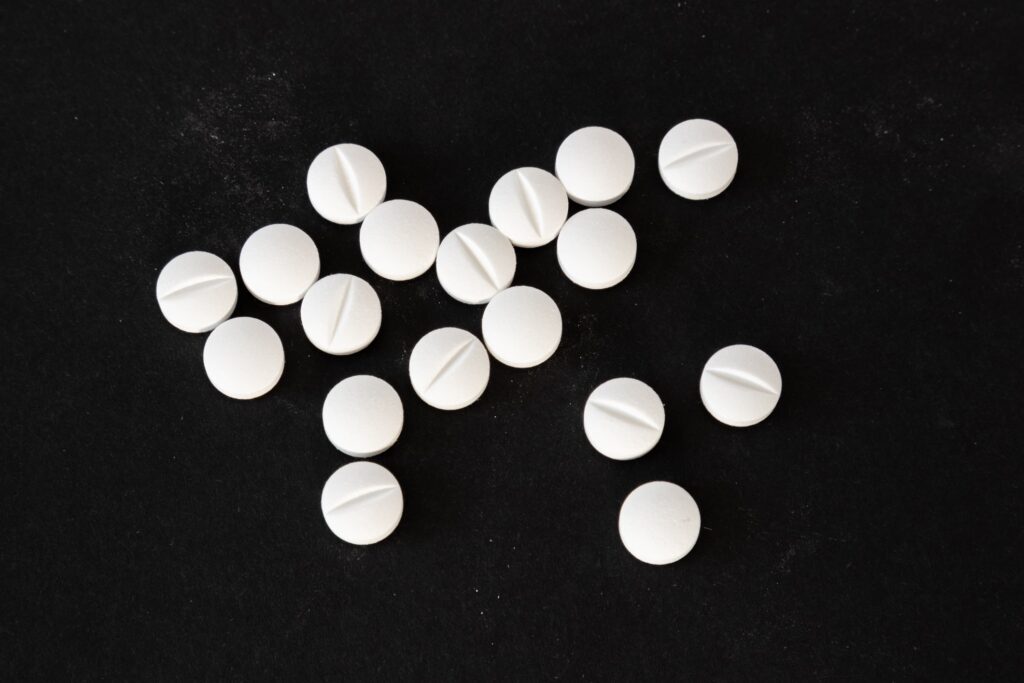 white opioid pills on a black background