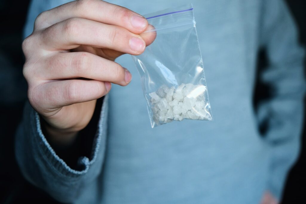 person holds baggies of illegal stimulant drugs