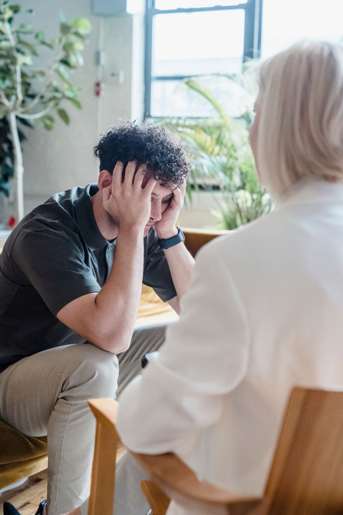 man going through GHB withdrawal talks to therapist